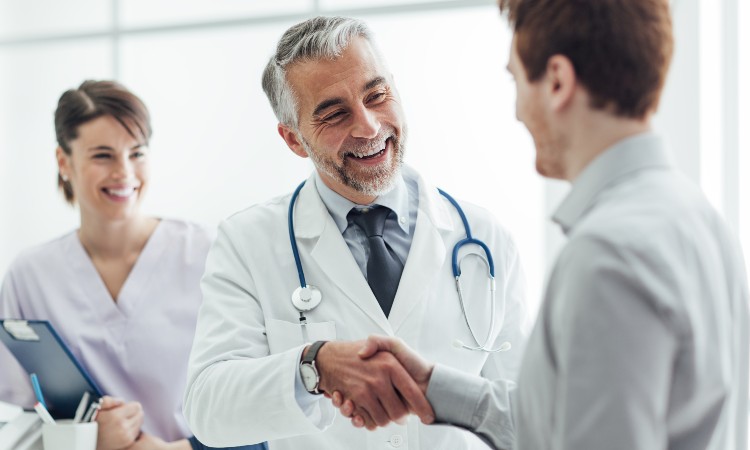 medical website design and marketing services with online payment feature near syracuse image of a patient shaking hand with doctor