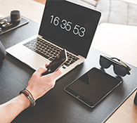 website design image of woman in front of computer with phone in hand testing website