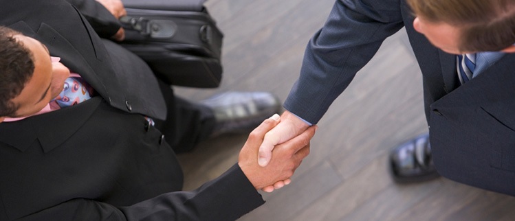 linkedin optimization image of two white collar professionals shaking hands