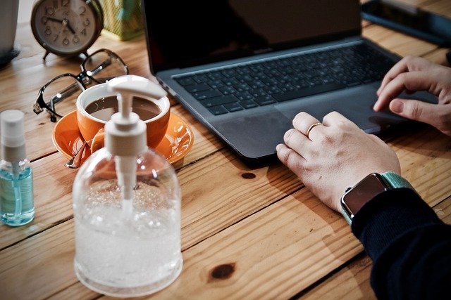 live chat support image of women working from home with hand sanitizer at work station