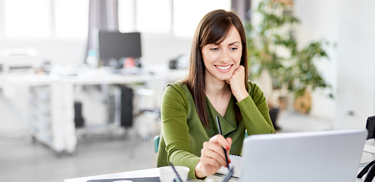 nursing home website design image of woman smiling while looking at laptop screen