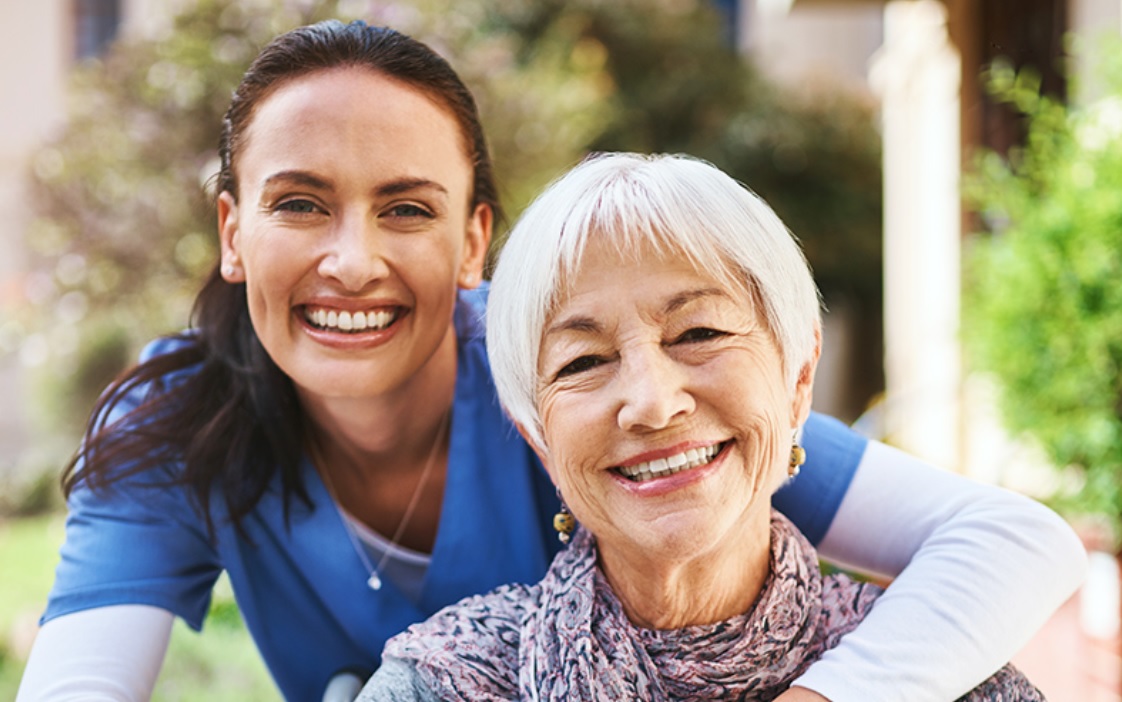 nursing home website design image of smiling nurse and elderly resident