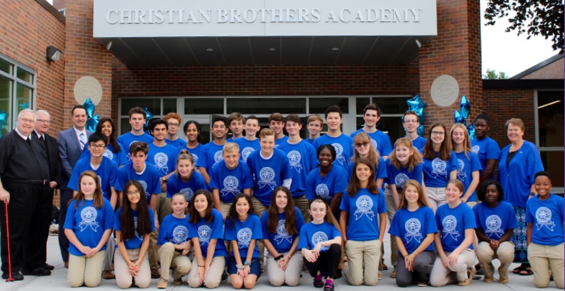 private school website design image of cba students in matching shirts in front of christian brothers academy sign