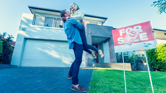 ada compliant website design image of couple celebrating in front of for sale sign in front of house with sold label on sign