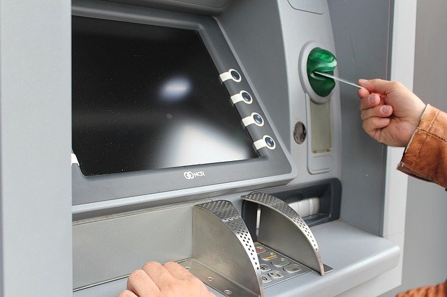 ada compliant website design image of person inserting card at atm