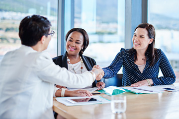 crm solutions syracuse ny image of white collar professionals shaking hands in a meeting