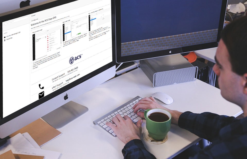 web design company syracuse ny image of person at office desk looking at content management system on computer