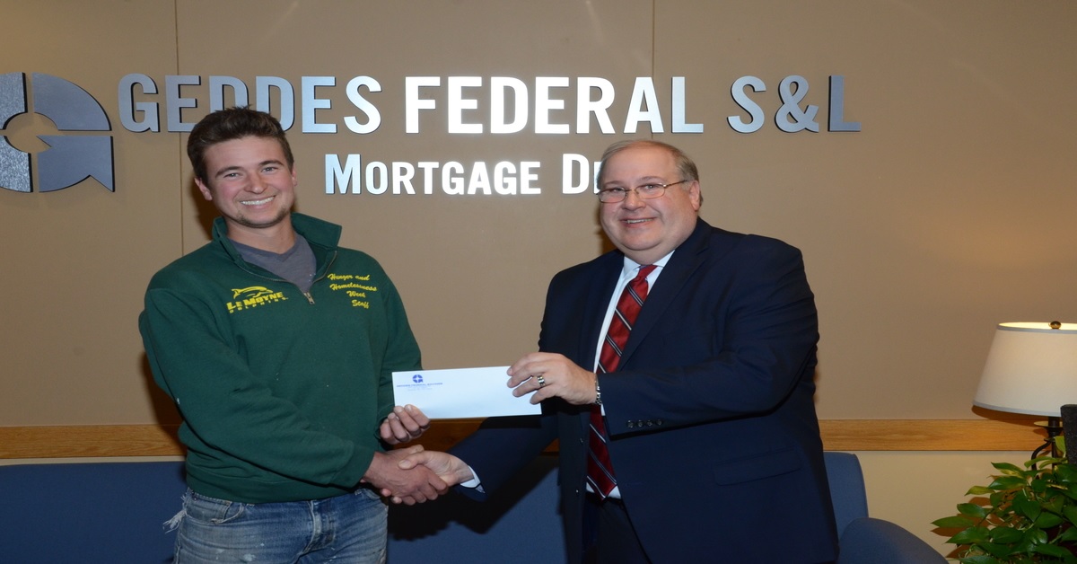 ada website design near syracuse ny image of brian dumond from geddes federal handing donation check to local charity