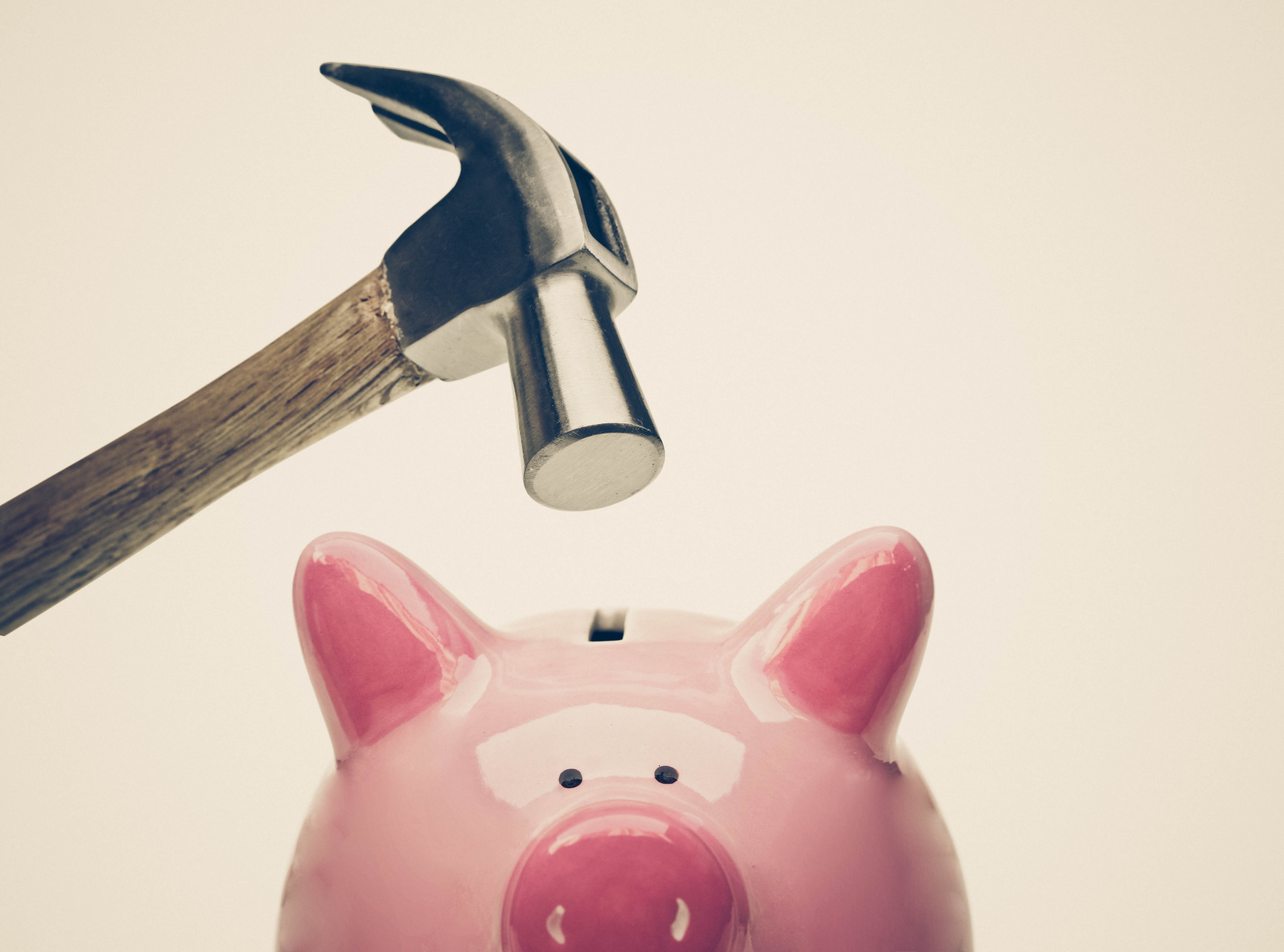 hammer above piggy bank compliance issues