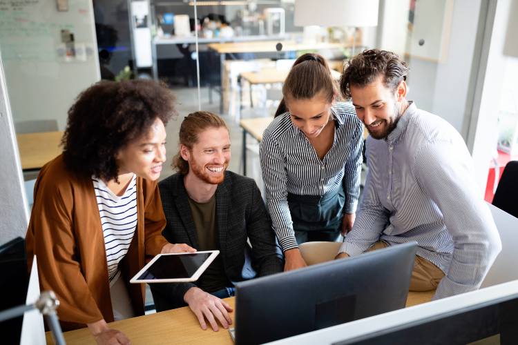 Instagram Business Page digital marketing team collaborate around computer with acs web design & SEO near syracuse ny