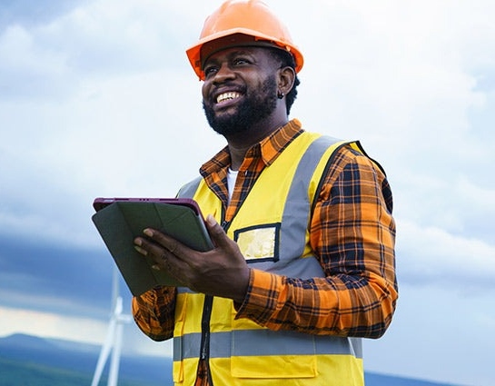 consulting website design for recruiting construction worker smiling holding tablet