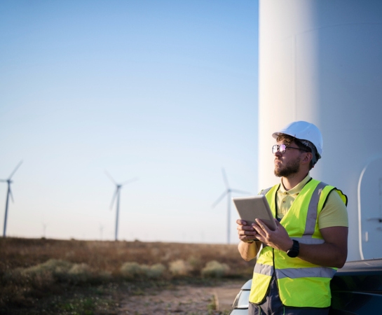 ecommerce website design unimar engineer holding tablet looking at windmills