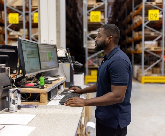 ecommerce website design for increased sales warehouse employee on computer