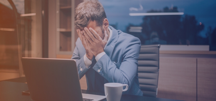 a website builder may cost more than custom web design business owner struggling on computer
